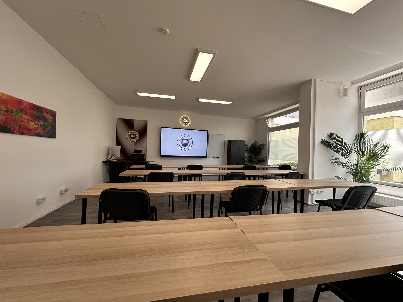 Schulungsraum des fairInstitut mit Tischen und Sonnenlicht in Berlin